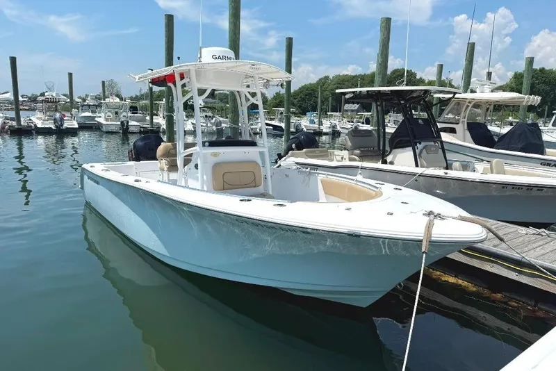 The Image of 2017 Sportsman Open 232 Center Console boat docked at marina. - 0