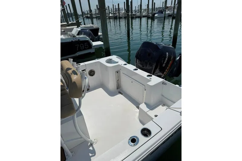 Slide: The Image of 2017 Sportsman Open 232 Center Console boat docked with Yamaha outboard motor. - 5