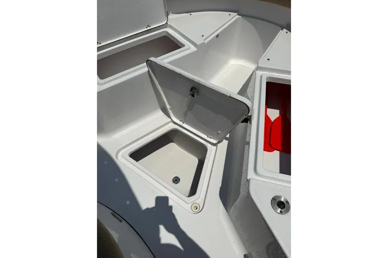 Slide: The Image of 2017 Sportsman Open 232 Center Console boat storage compartments open. - 21