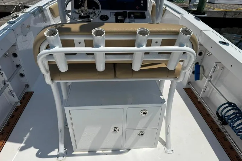 Slide: The Image of 2017 Sportsman Open 232 Center Console boat interior with rod holders and storage compartments. - 26