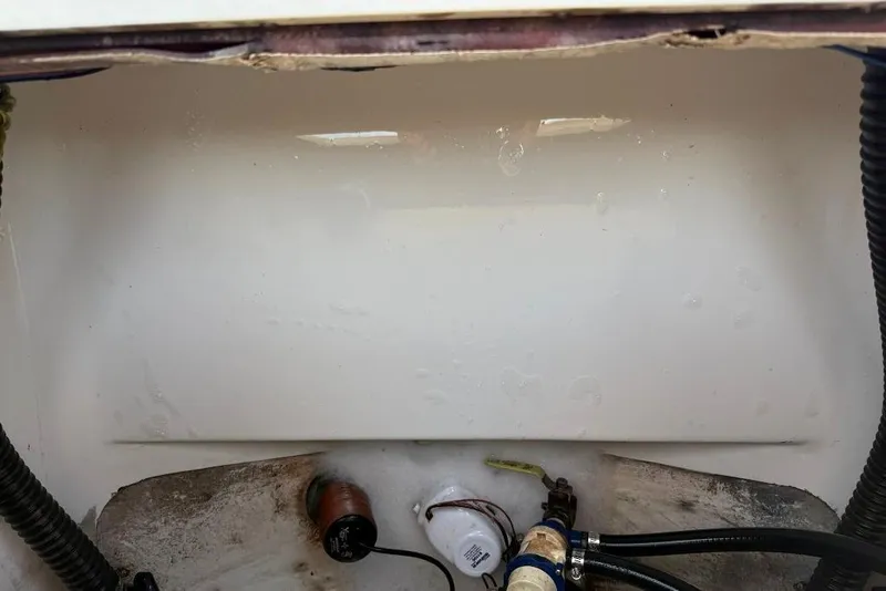 Slide: The Image of 2017 Sportsman Open 232 Center Console bilge area with hoses and pump components. - 37