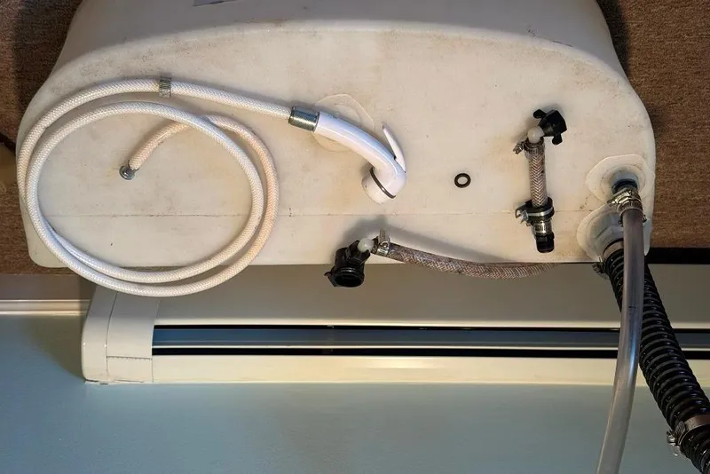 Slide: The Image of 2017 Sportsman Open 232 Center Console plumbing components with hoses and fittings. - 51