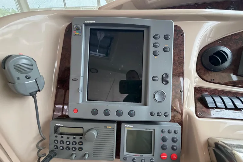 Slide: The Image of Control panel of a 2002 Sea Ray 480 Motor Yacht with Raytheon navigation equipment. - 12