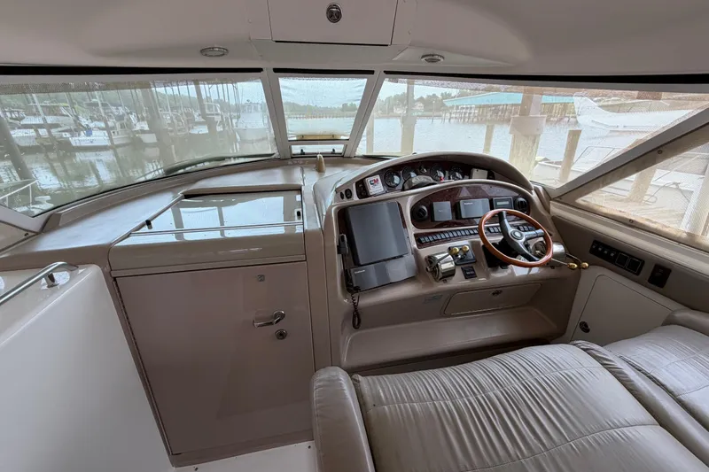 Slide: The Image of 2002 Sea Ray 480 Motor Yacht helm with steering wheel and control panel. - 11
