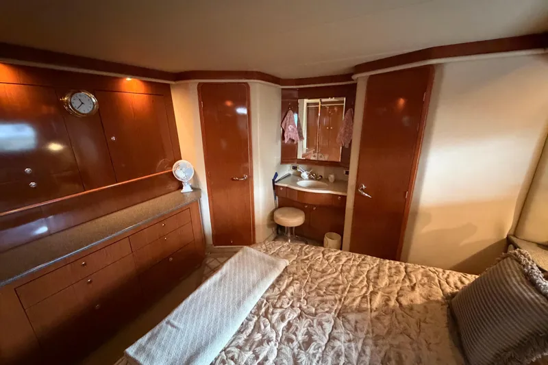 Slide: The Image of Luxurious 2002 Sea Ray 480 Motor Yacht cabin with elegant wood finishes. - 21