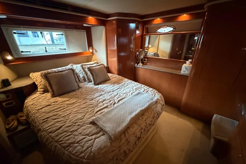 Slide: The Image of Luxurious bedroom interior of 2002 Sea Ray 480 Motor Yacht with cozy bedding and elegant wood finishes. - 24