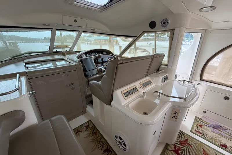 Slide: The Image of Interior of 2002 Sea Ray 480 Motor Yacht with helm, seating, and sink area. - 8