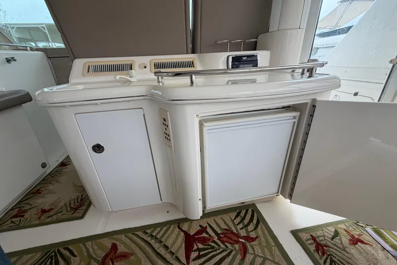 Slide: The Image of 2002 Sea Ray 480 Motor Yacht interior with open cabinet and mini fridge. - 9
