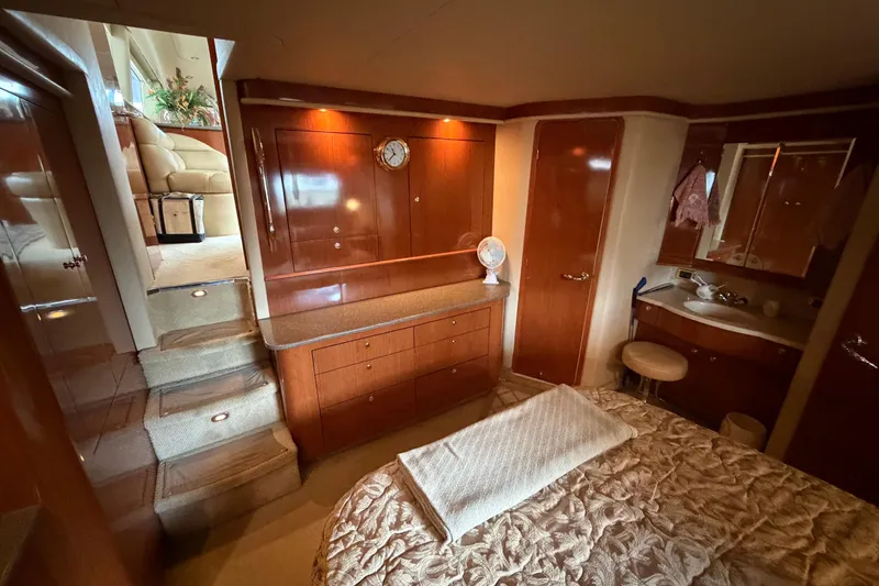 Slide: The Image of Luxurious 2002 Sea Ray 480 Motor Yacht interior with elegant wood cabinetry and cozy bedroom. - 20
