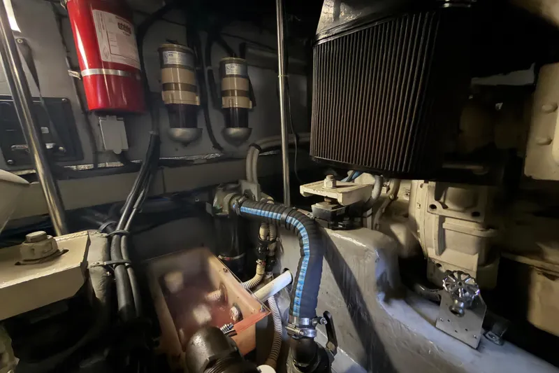 Slide: The Image of Engine room of a 2002 Sea Ray 480 Motor Yacht, featuring mechanical components and fire extinguisher. - 47
