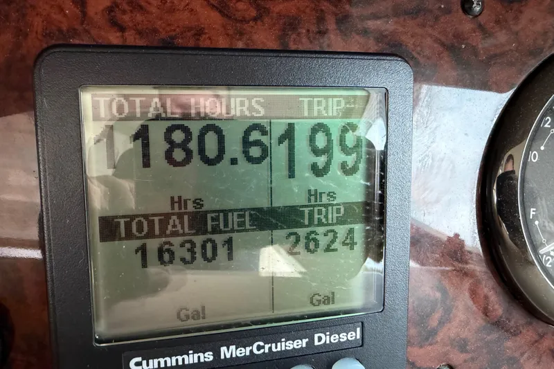 Slide: The Image of Dashboard display of a 2002 Sea Ray 480 Motor Yacht showing engine hours and fuel usage. - 49