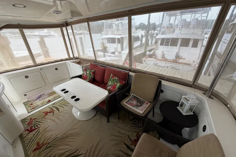 Slide: The Image of Luxurious 2002 Sea Ray 480 Motor Yacht interior with cozy seating and scenic marina view. - 7