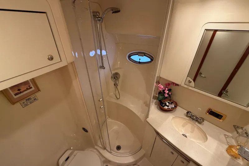 Slide: The Image of Luxurious bathroom in 2002 Sea Ray 480 Motor Yacht with shower, sink, and mirror. - 30