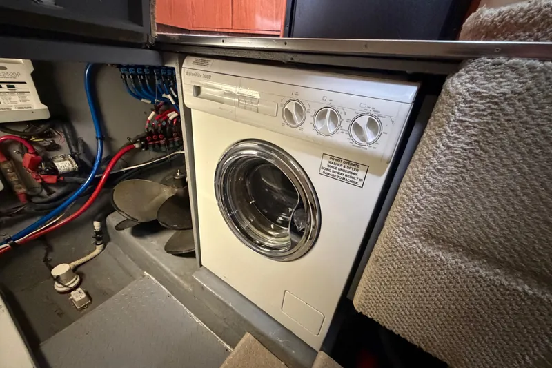 Slide: The Image of Laundry area inside 2002 Sea Ray 480 Motor Yacht with washer and wiring. - 32