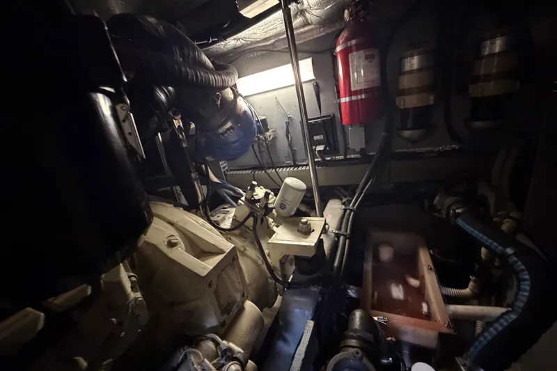 Slide: The Image of Engine room of a 2002 Sea Ray 480 Motor Yacht with visible machinery and fire extinguisher. - 46