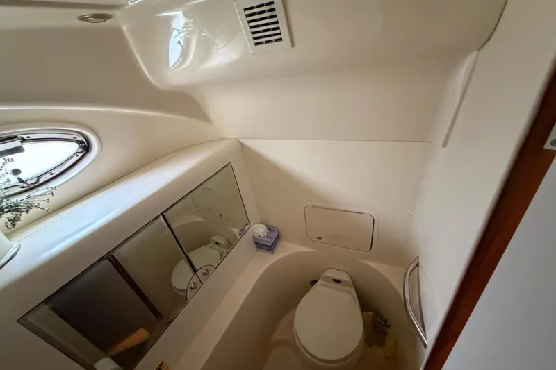 Slide: The Image of Bathroom interior of 2002 Sea Ray 480 Motor Yacht with toilet and mirrored cabinet. - 23