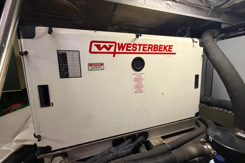 Slide: The Image of Westerbeke generator in 2002 Sea Ray 480 Motor Yacht engine room, surrounded by hoses. - 45