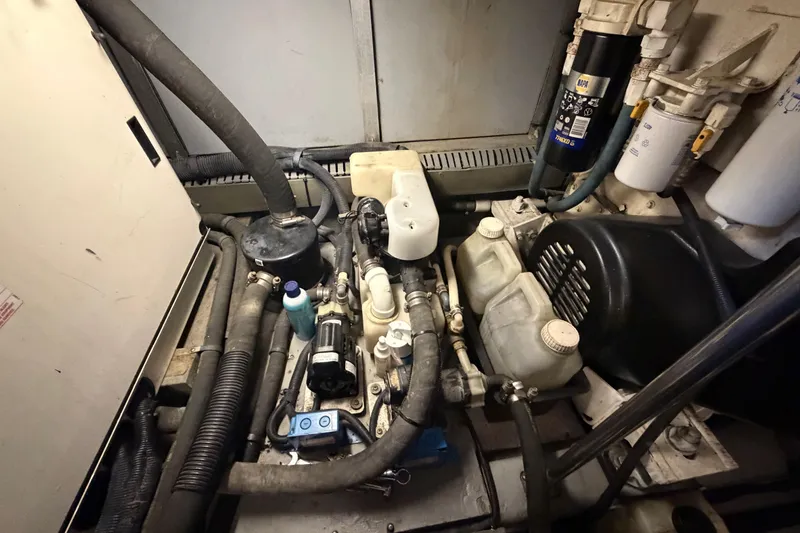 Slide: The Image of Engine room of a 2002 Sea Ray 480 Motor Yacht, showcasing mechanical components and hoses. - 42