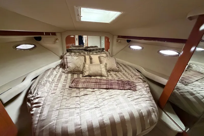 Slide: The Image of Luxurious bedroom interior of 2002 Sea Ray 480 Motor Yacht with plush bedding. - 29