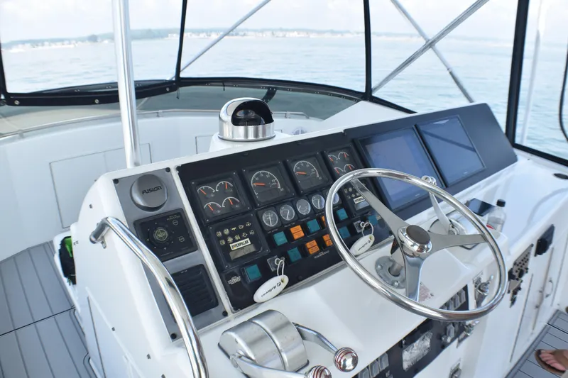 Slide: The Image of Helm of 1995 Hatteras 54 Convertible yacht with navigation controls and steering wheel. - 25