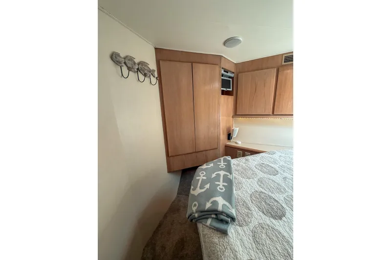Slide: The Image of Interior of 1995 Hatteras 54 Convertible yacht with wooden cabinets and nautical-themed decor. - 40