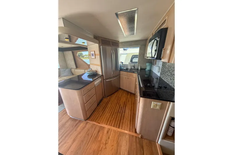 Slide: The Image of Interior of 1995 Hatteras 54 Convertible yacht with modern kitchen design. - 44