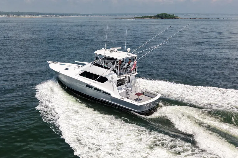 Slide: The Image of 1995 Hatteras 54 Convertible yacht cruising on open water, aerial view. - 26