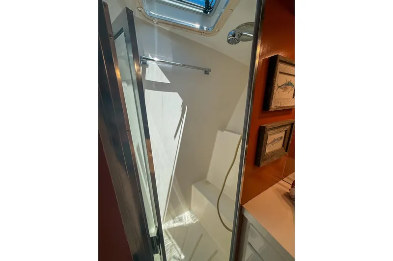 Slide: The Image of Shower area in 1995 Hatteras 54 Convertible yacht with framed fish artwork. - 30