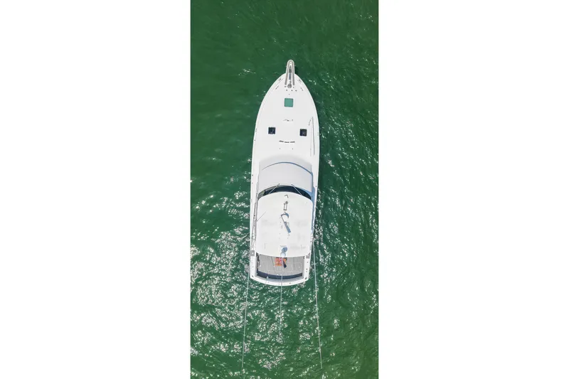Slide: The Image of Aerial view of 1995 Hatteras 54 Convertible yacht on green water. - 13