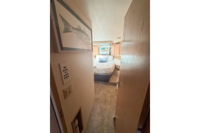 Slide: The Image of Cozy bedroom interior of 1995 Hatteras 54 Convertible yacht with nautical decor. - 38