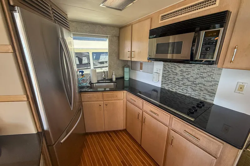 Slide: The Image of Modern kitchen in a 1995 Hatteras 54 Convertible yacht with stainless steel appliances. - 50