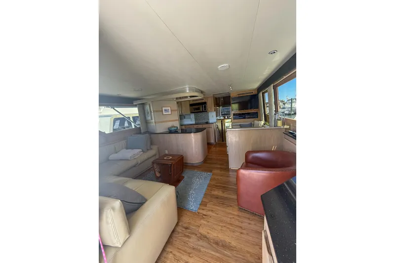 Slide: The Image of Interior of 1995 Hatteras 54 Convertible yacht with modern furnishings and wood flooring. - 48