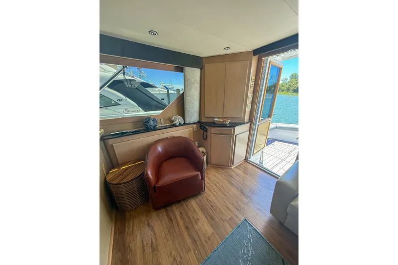 Slide: The Image of Interior of 1995 Hatteras 54 Convertible yacht with leather chair and scenic water view. - 46