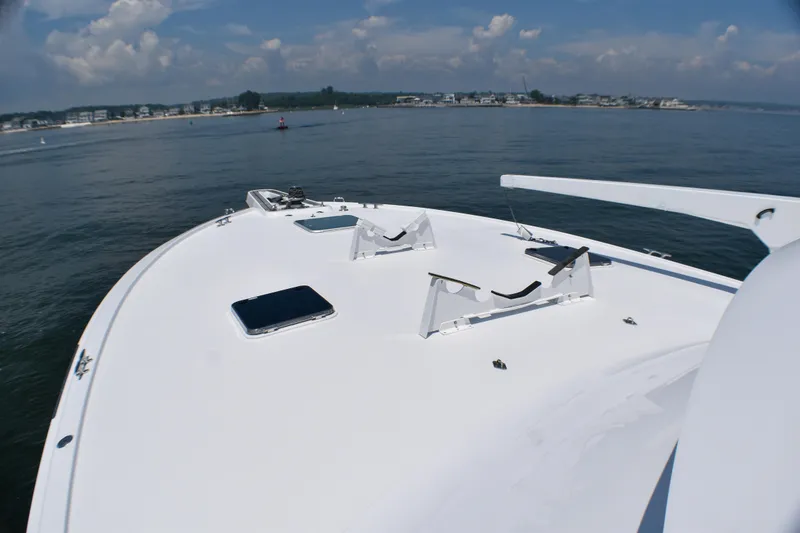 Slide: The Image of Bow view of 1995 Hatteras 54 Convertible yacht on calm waters. - 15