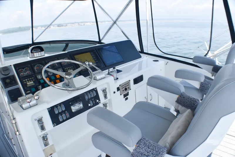 Slide: The Image of Cockpit of 1995 Hatteras 54 Convertible yacht with steering wheel and navigation controls. - 22