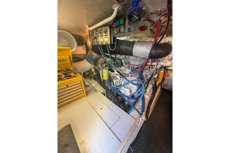 Slide: The Image of Engine room of 1995 Hatteras 54 Convertible yacht, showcasing machinery and control panel. - 52