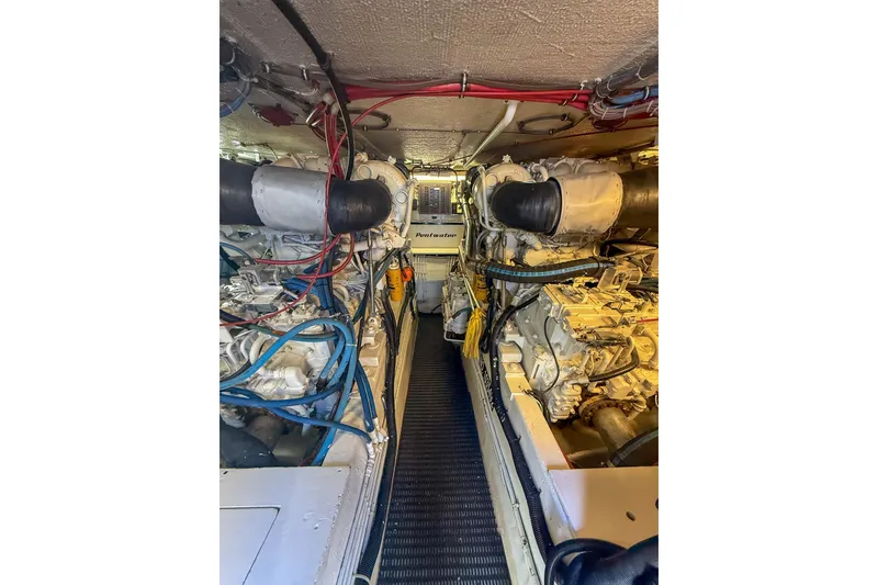 Slide: The Image of Engine room of 1995 Hatteras 54 Convertible yacht, showcasing dual engines and wiring. - 51