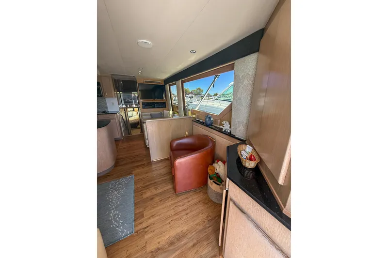 Slide: The Image of Interior of 1995 Hatteras 54 Convertible yacht with wood flooring and modern furnishings. - 49