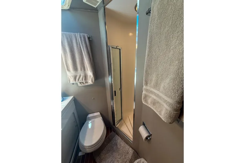Slide: The Image of Bathroom interior of 1995 Hatteras 54 Convertible yacht with shower and towels. - 36