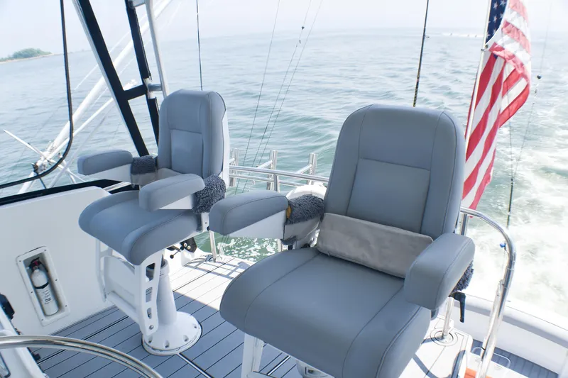 Slide: The Image of Luxury seating on 1995 Hatteras 54 Convertible yacht with ocean view and American flag. - 21