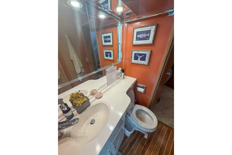 Slide: The Image of Bathroom interior of 1995 Hatteras 54 Convertible yacht with orange walls and framed art. - 31