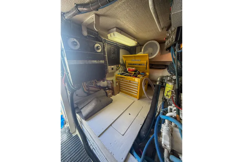Slide: The Image of Engine room of 1995 Hatteras 54 Convertible with tools and equipment. - 55