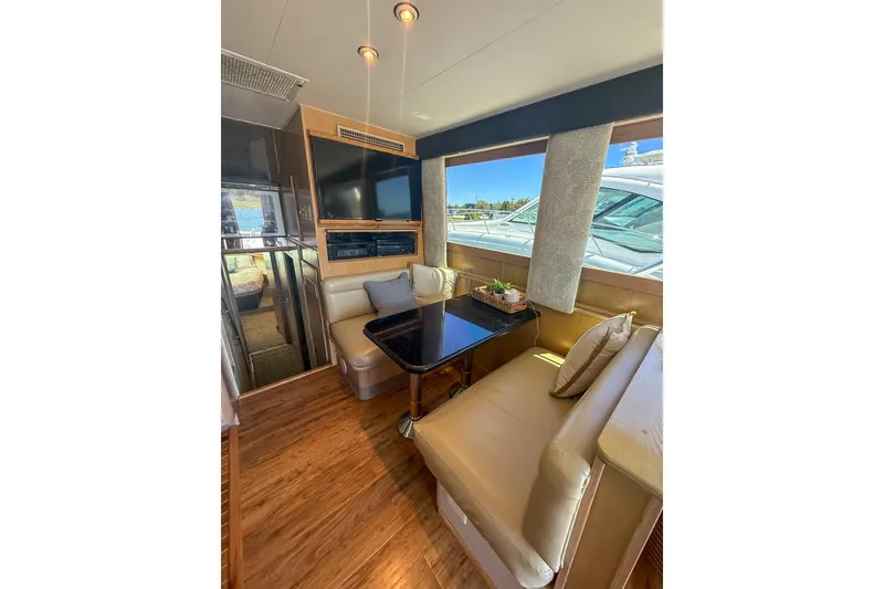 Slide: The Image of Interior of 1995 Hatteras 54 Convertible yacht with cozy seating and modern decor. - 47