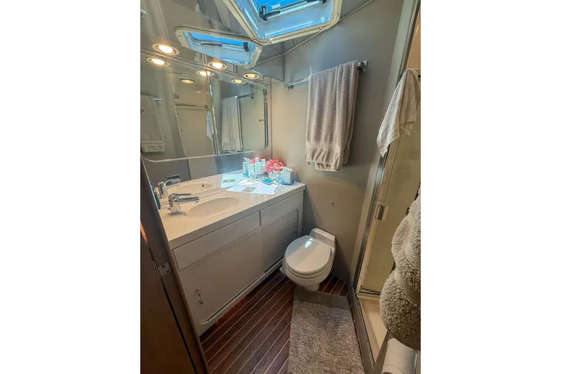 Slide: The Image of Bathroom interior of 1995 Hatteras 54 Convertible yacht, featuring sink, toilet, and shower. - 35
