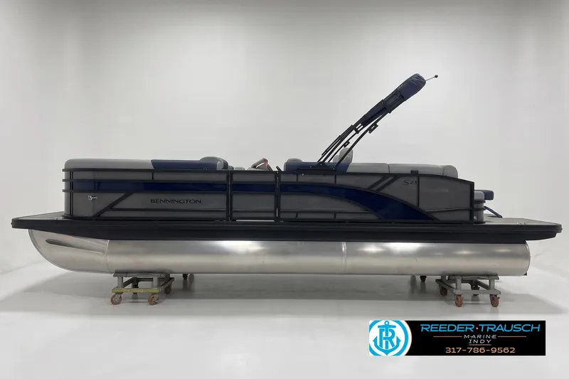 Slide: The Image of 2027 Bennington 23 SLJ pontoon boat in showroom, side view with sleek design. - 2