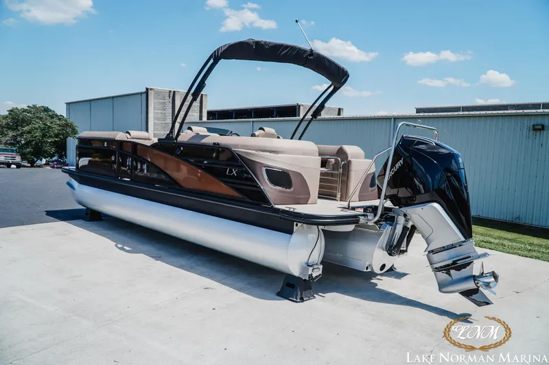Slide: The Image of 2024 Bennington 24LXSFB pontoon boat with Mercury outboard at Lake Norman Marina. - 4