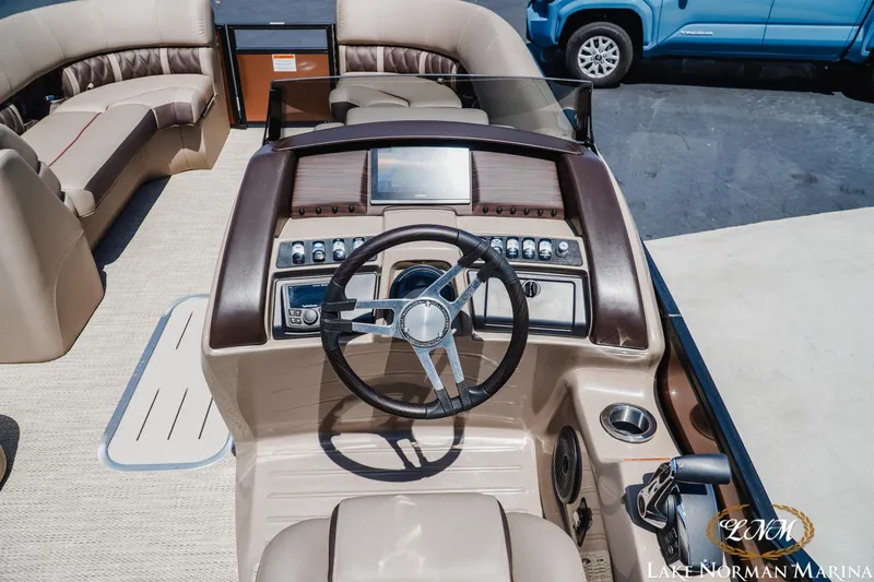 Slide: The Image of 2024 Bennington 24LXSFB boat interior with steering wheel and dashboard controls. - 11