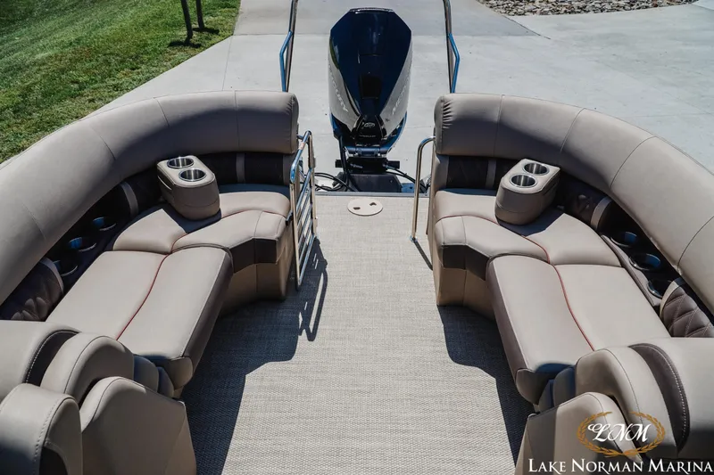 Slide: The Image of 2024 Bennington 24LXSFB pontoon boat with plush seating and cup holders at Lake Norman Marina. - 22