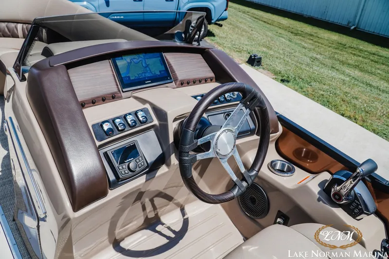Slide: The Image of 2024 Bennington 24LXSFB boat dashboard with steering wheel and navigation display. - 12
