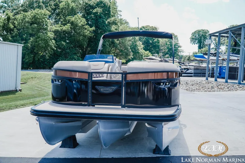 Slide: The Image of 2024 Bennington 24LXSFB pontoon boat at Lake Norman Marina, surrounded by greenery. - 3